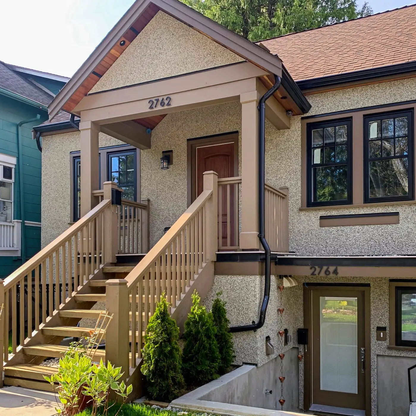 Craftsman-style house with a covered porch and wooden front stairs