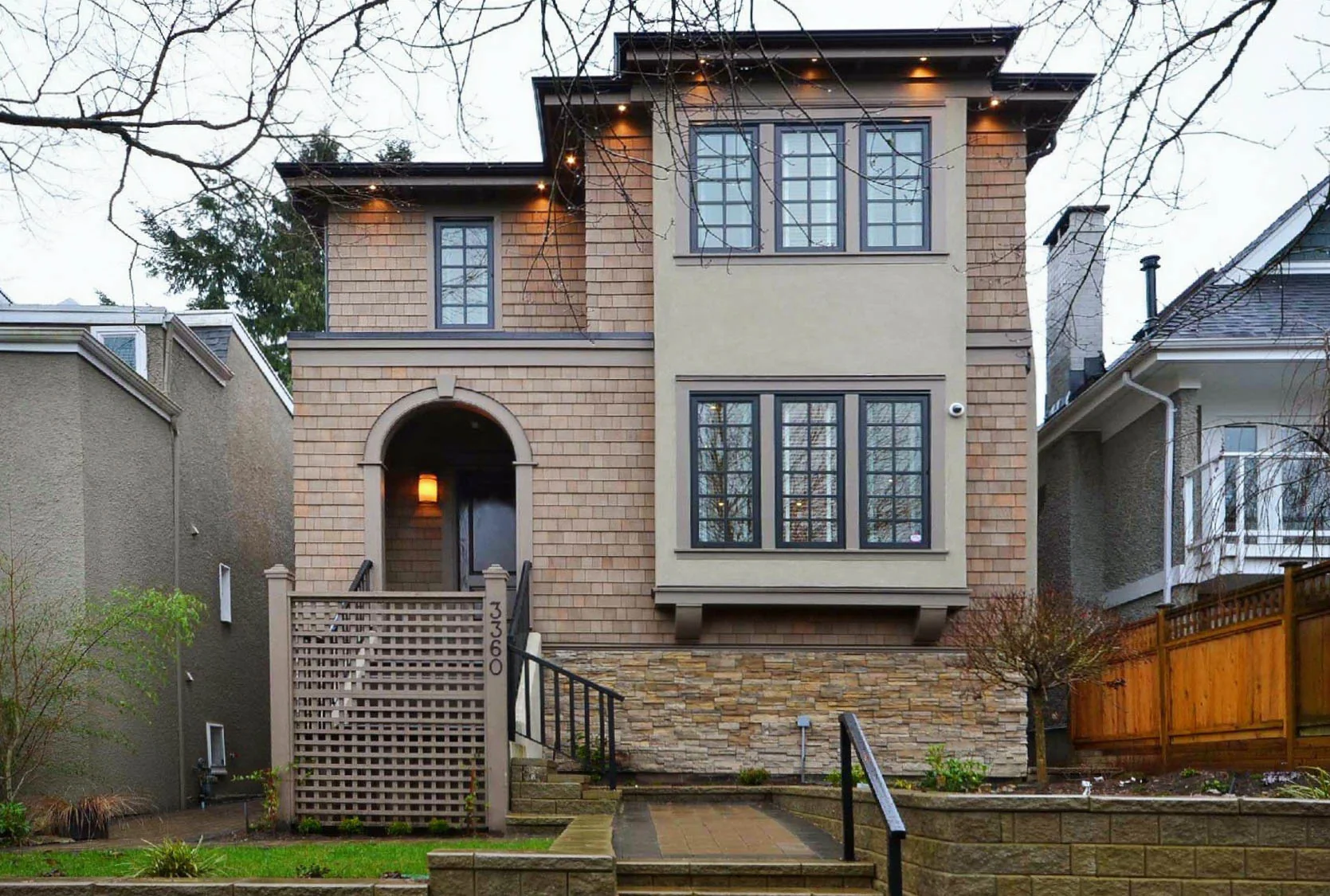 A stone-clad house with arched windows