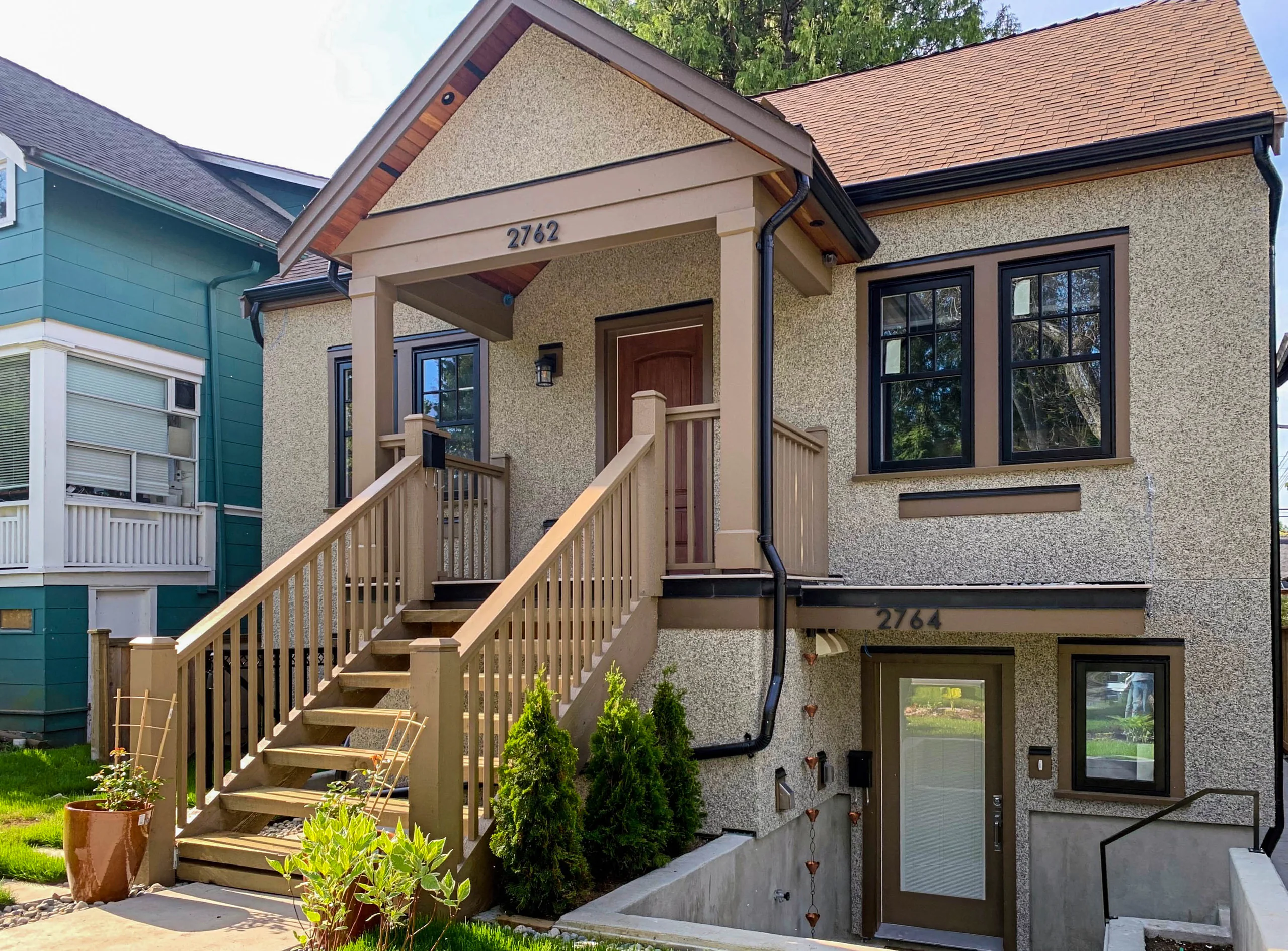 Craftsman-style house with a covered porch and wooden front stairs
