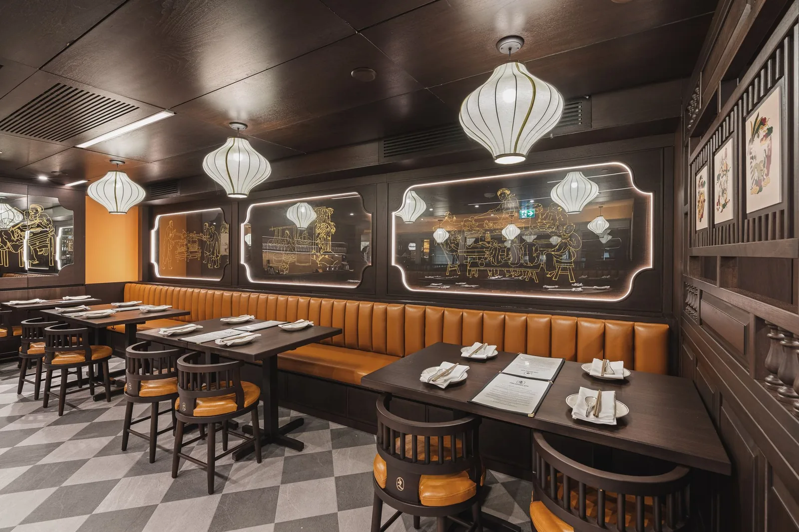 Booth seating under lanterns, with framed prints and backlit etched panels, Linh Noodle Bar by Costar Construction, Vancouver