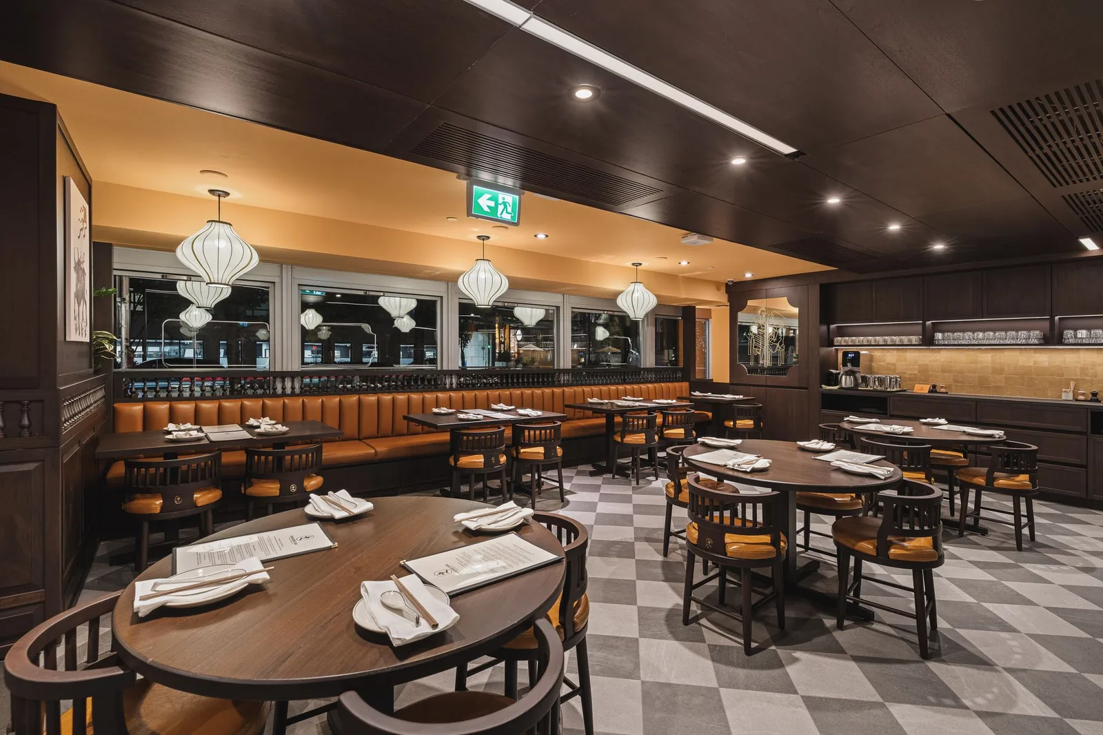 Dining room with round and square tables, booths and window lanterns, Linh Noodle Bar by Costar Construction, Vancouver