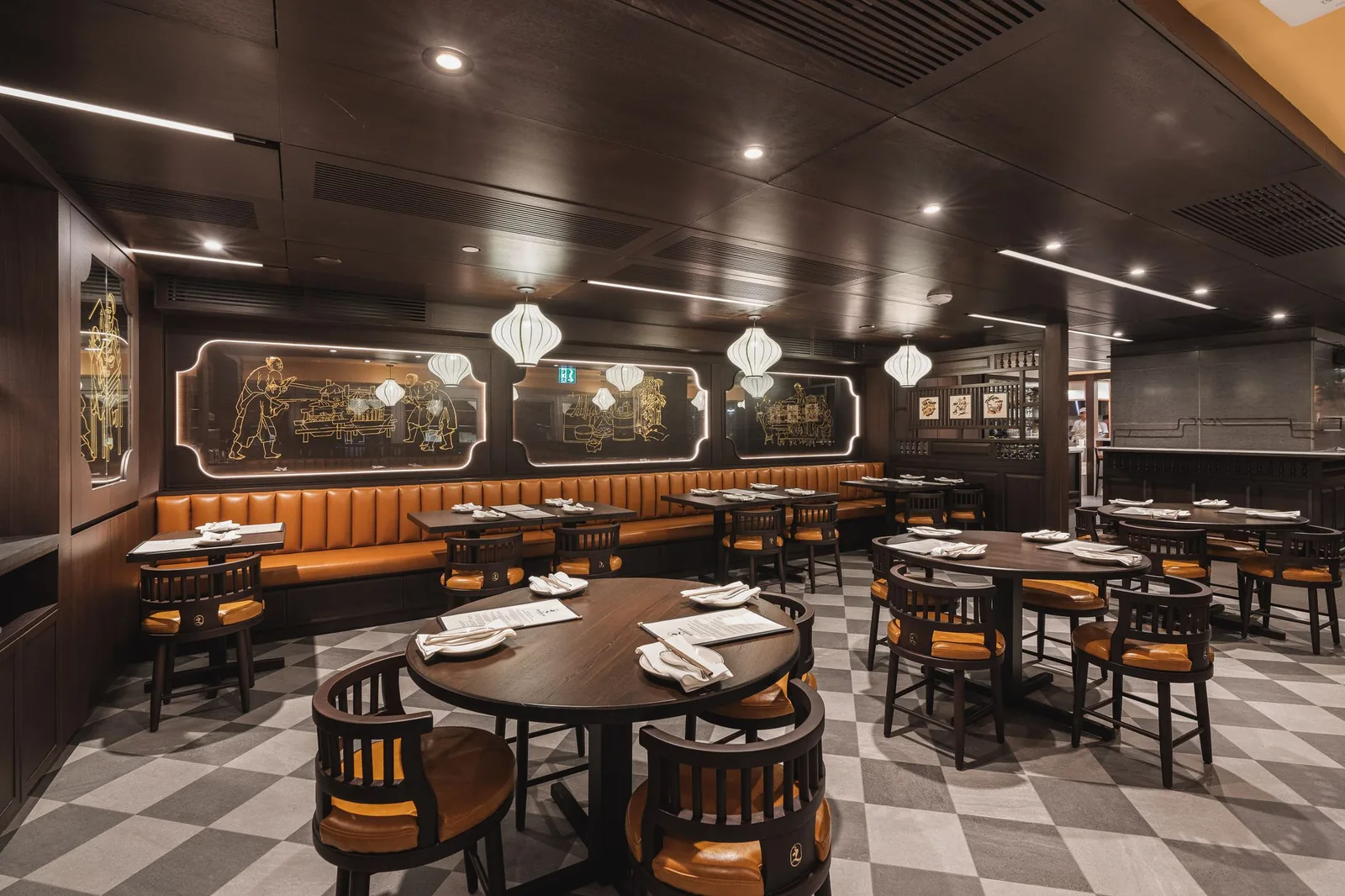 Round tables and booths beside backlit etched glass panels, Linh Noodle Bar by Costar Construction, Vancouver