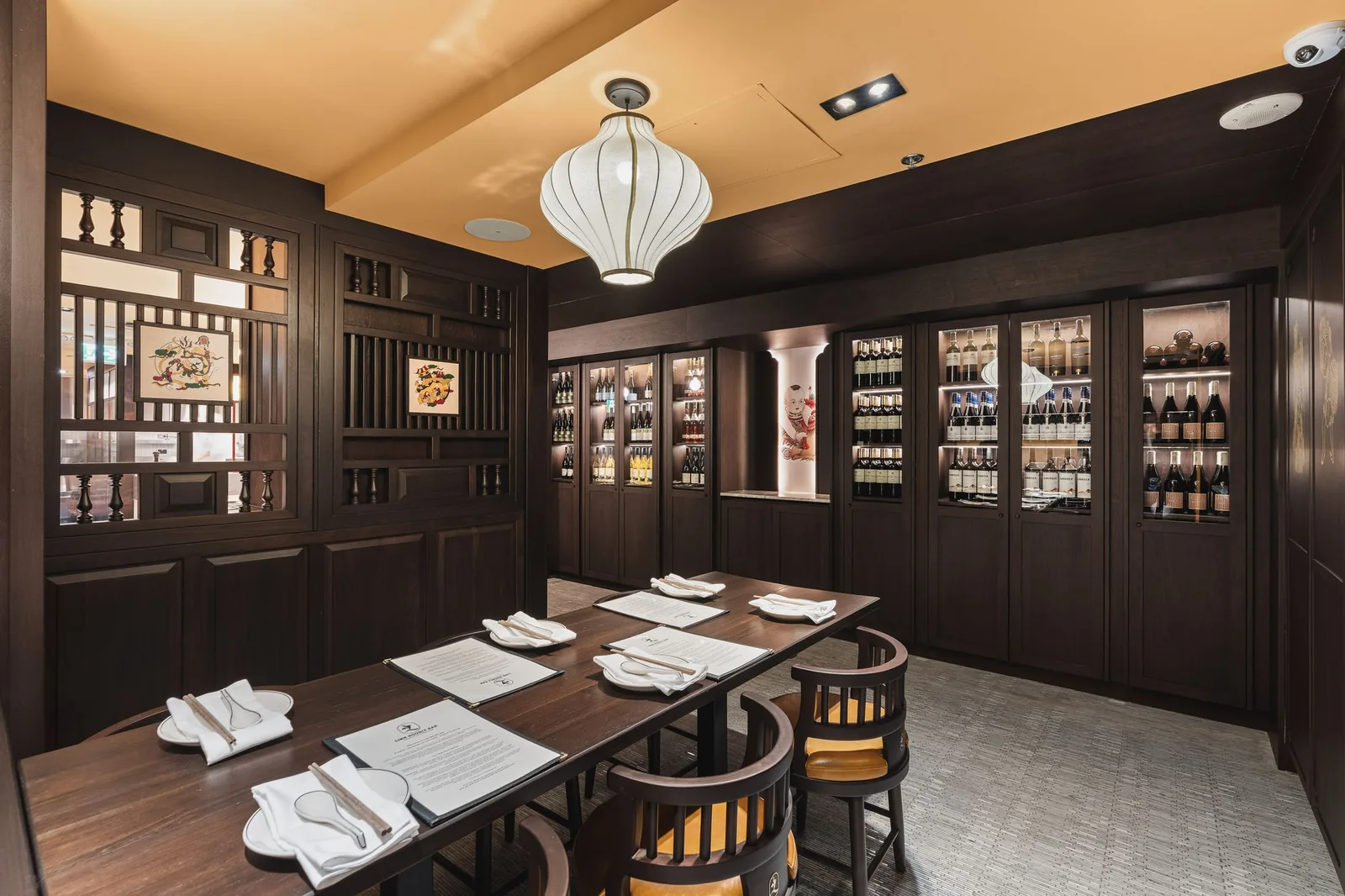 Private room table beside wood screens and wine cabinets, Linh Noodle Bar by Costar Construction, Vancouver