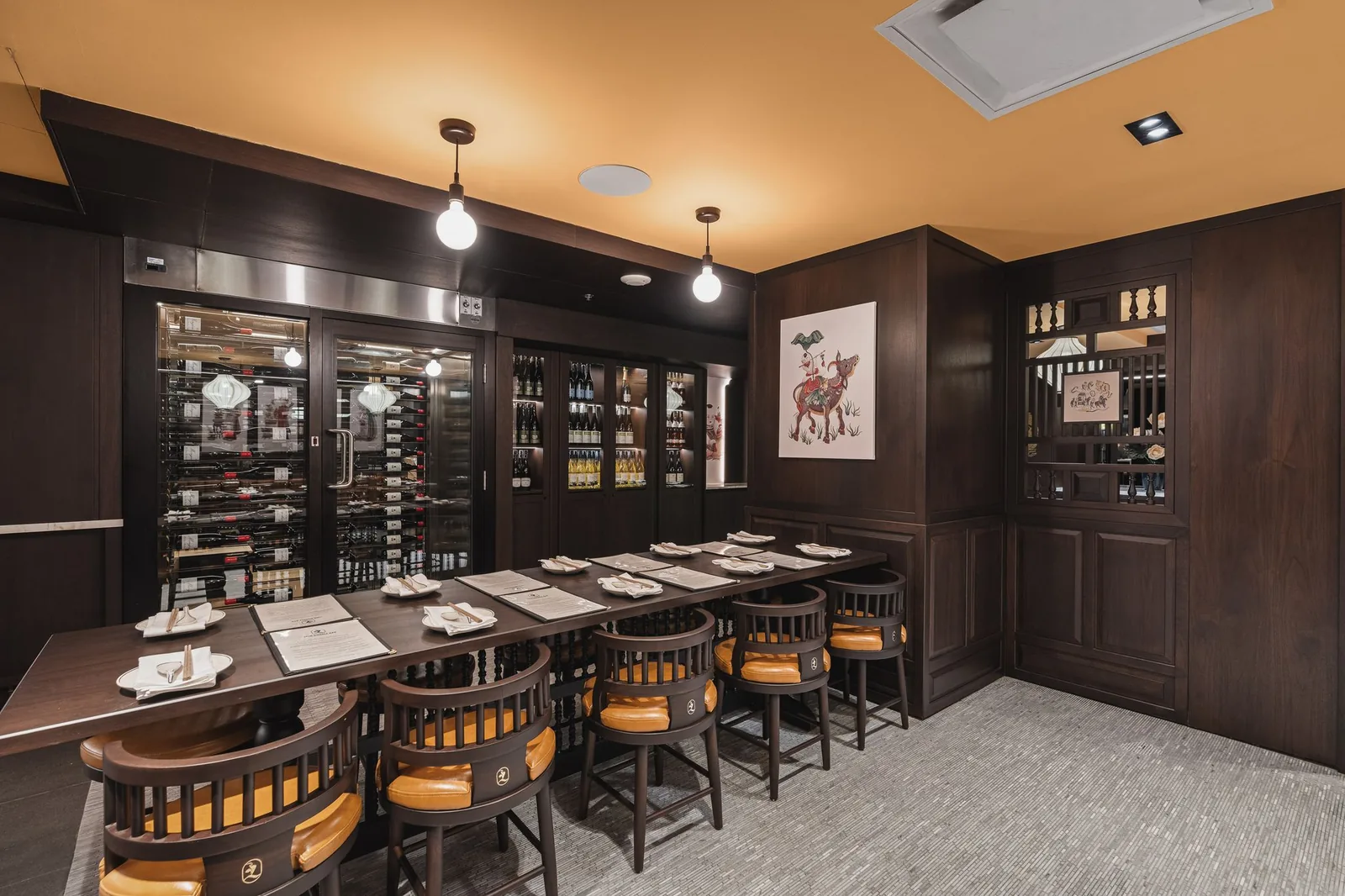 Long table beside the glass wine room and wine cabinets, Linh Noodle Bar by Costar Construction, Vancouver