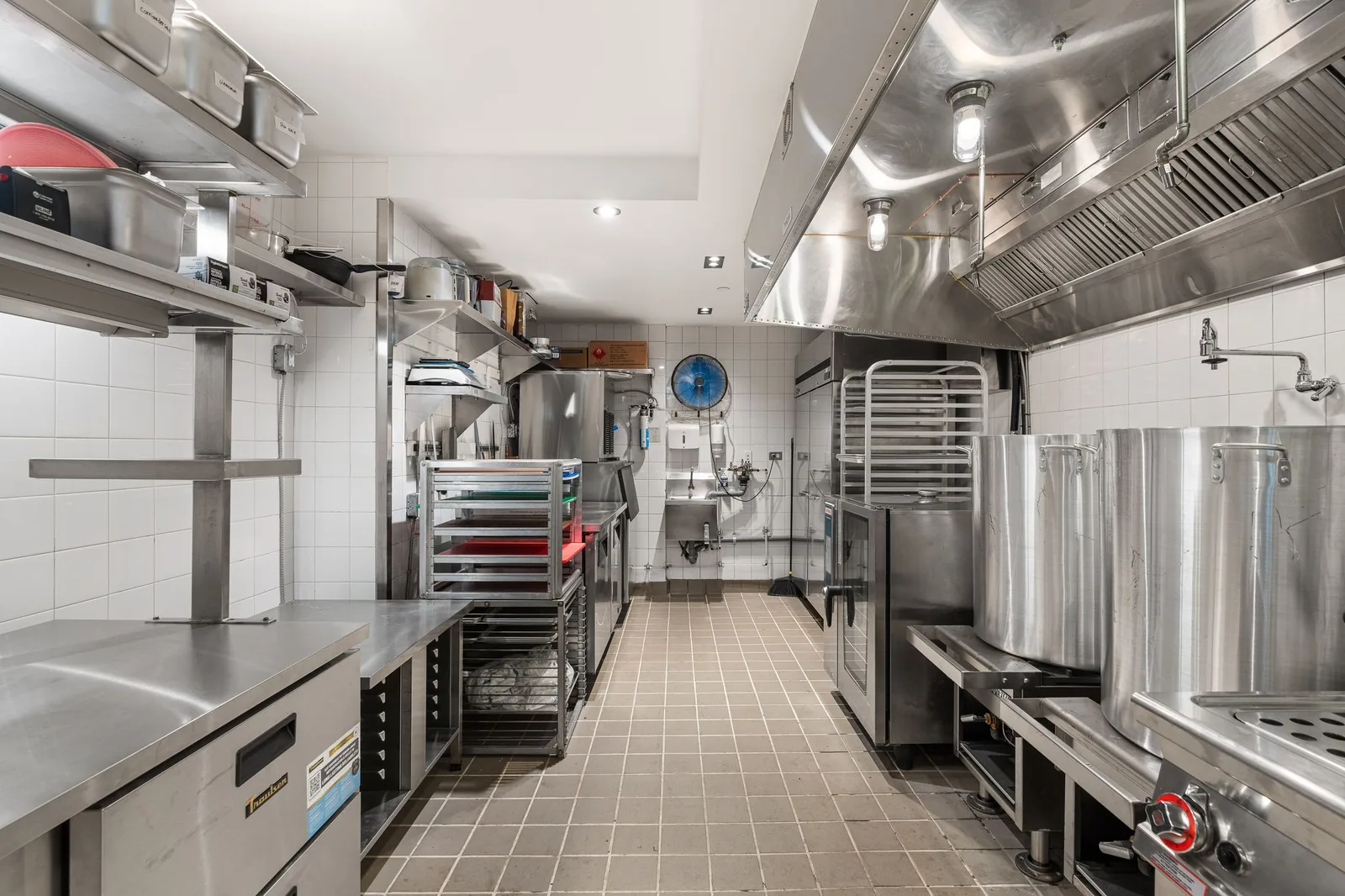 Kitchen line with stainless steel shelves, a range hood and stock pots, Linh Noodle Bar by Costar Construction, Vancouver