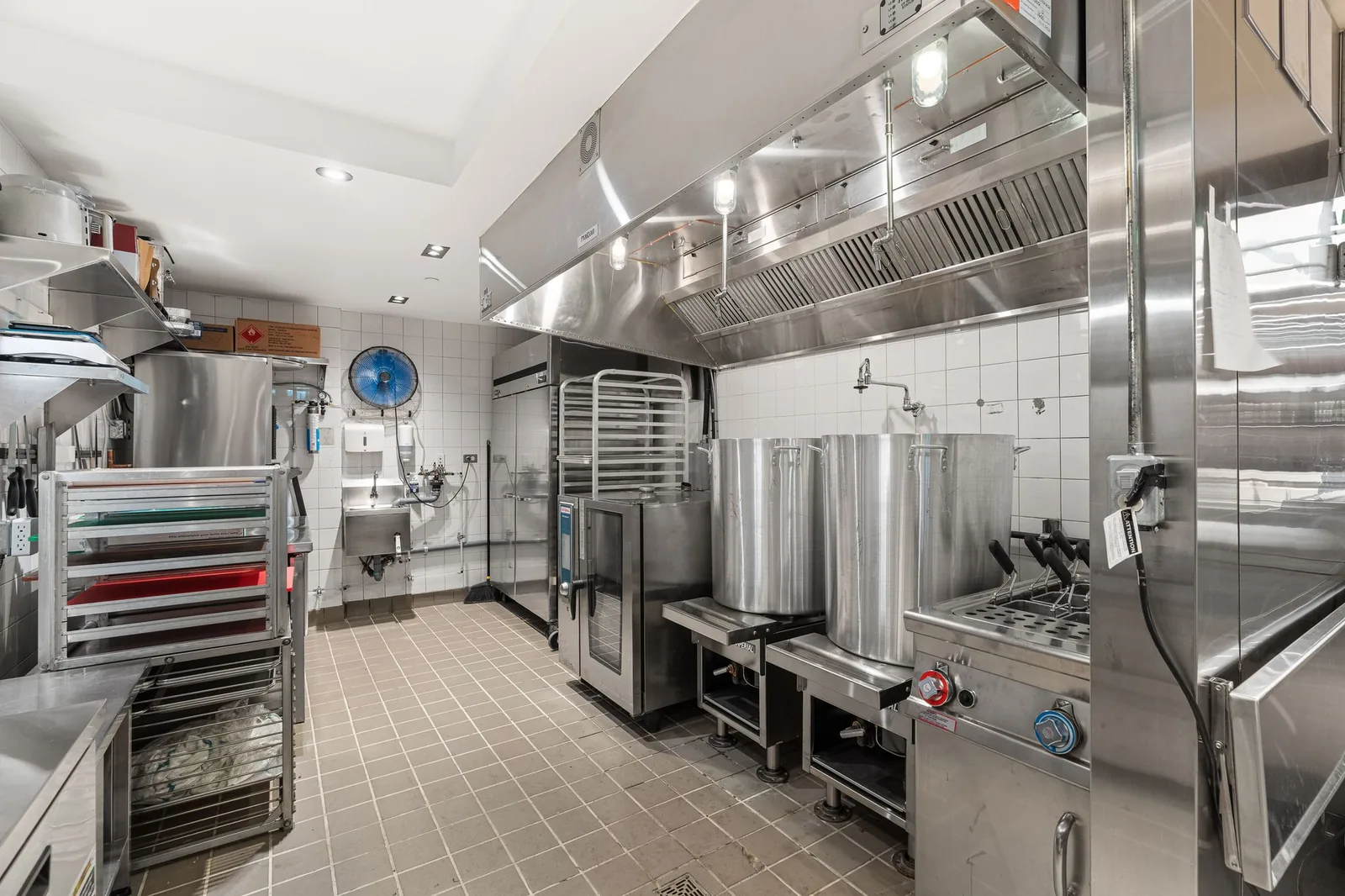Stainless steel kitchen with stock pot burners and a large oven, Linh Noodle Bar by Costar Construction, Vancouver