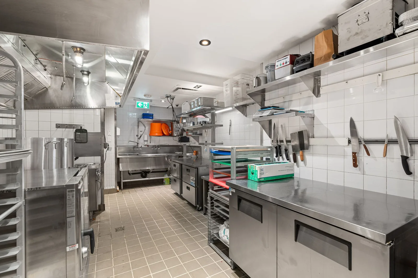 Prep tables, a knife rail and shelving in the kitchen, Linh Noodle Bar by Costar Construction, Vancouver